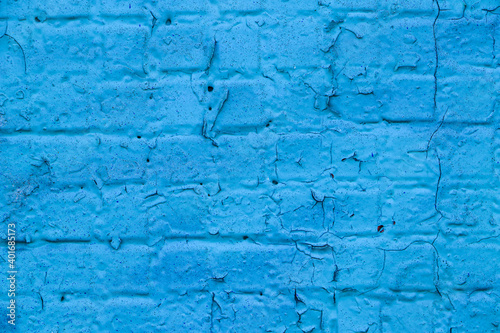 Old brick wall close-up covered with light blue paint. Empty backdrop. 