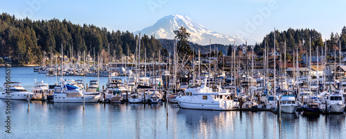 Marina in Gig Harbor Washington with sail and fishing boats, mt rainier in the background