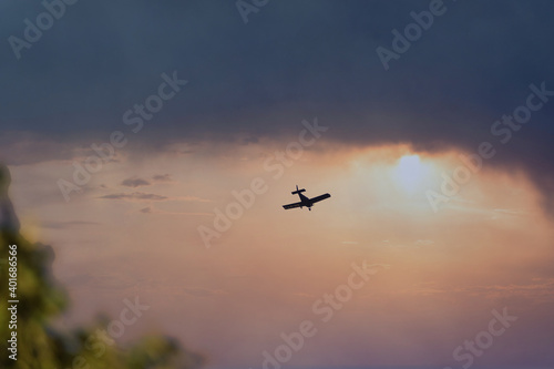Silhouette of a small plane over a dramatic sky at sunset © Miguel Ángel RM