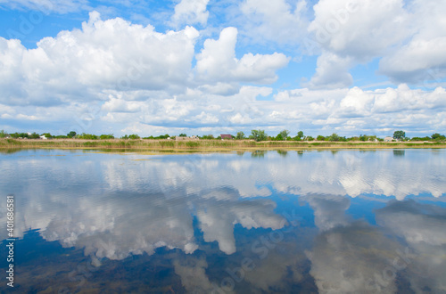 Perfect reflection of bright blue sky in the river. River Samara, Ukraine.