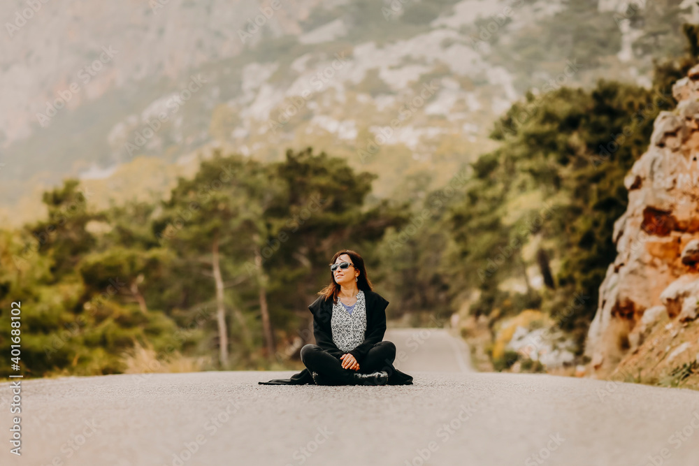 Eco-friendly young woman sitting in the middle of the road in Turkey