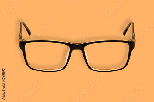 Background on the theme of glasses. Black glasses seamless pattern on an orange background.