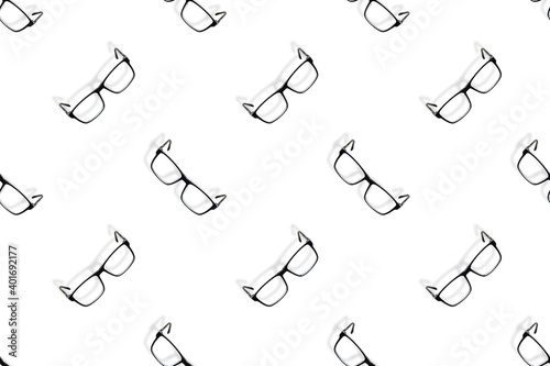 Background on the theme of glasses. Black glasses seamless pattern on a white background.