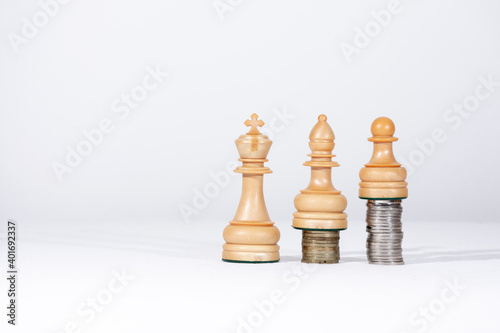 chess pieces and coins showing the concepts of equality and fairness.
