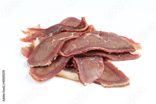 Portion of sliced ham meat isolated on white background. Prosciutto