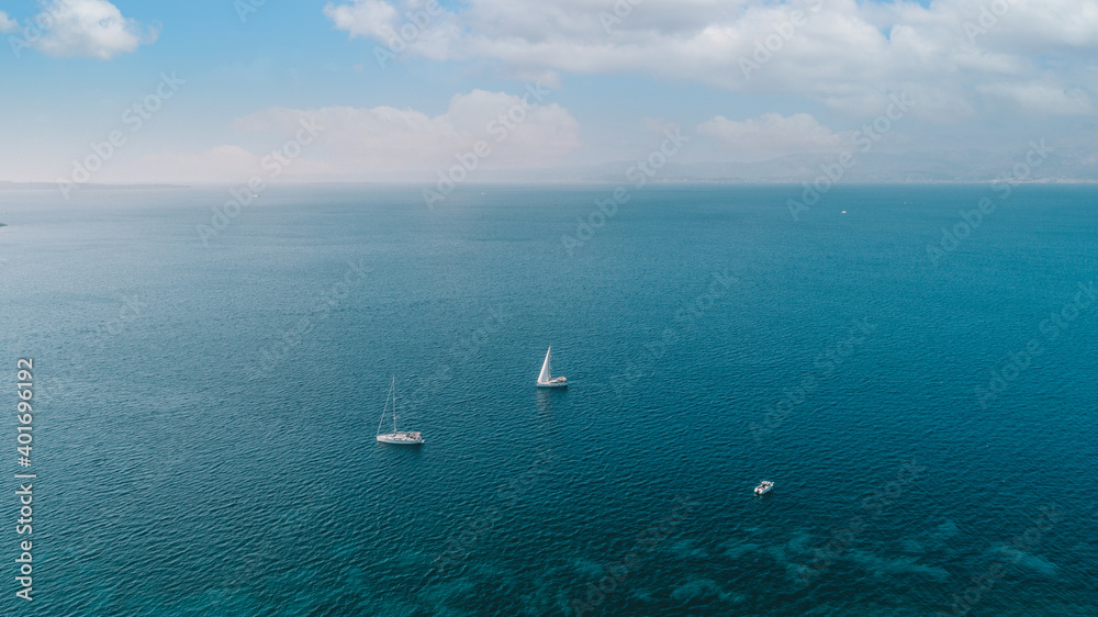 Aerial drone ultra wide photo of sail boat cruising in the deep blue Aegean sea,Turkey