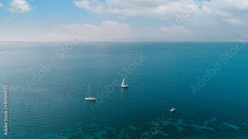 Aerial drone ultra wide photo of sail boat cruising in the deep blue Aegean sea,Turkey