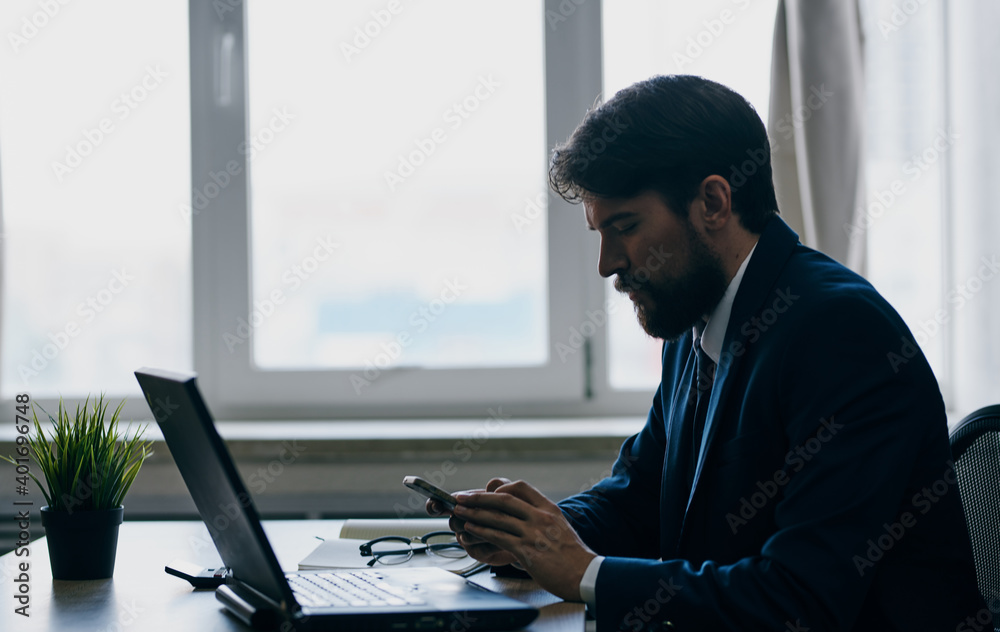Puzzled business man looks at the laptop at the table in the office work office Puzzled business man looks at the laptop at the table in the office work office