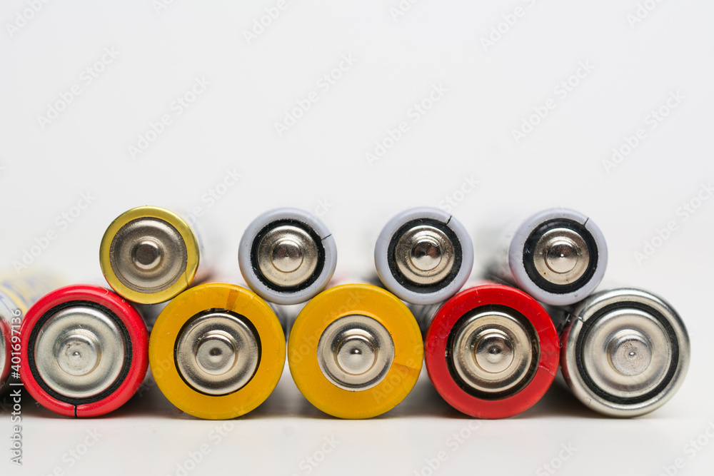 Spent batteries stacked in a row isolated on a white background. Spent batteries stacked in a row isolated on a white background.
