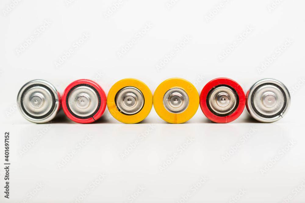 Spent batteries stacked in a row isolated on a white background. Spent batteries stacked in a row isolated on a white background.