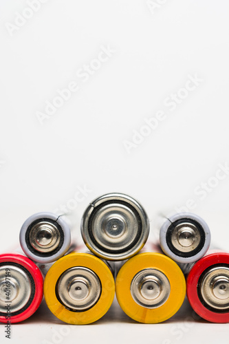 Spent batteries stacked in a row isolated on a white background.