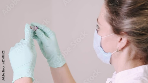 Blood testing, plr test, coronavirus concept. The nurse is looking at blood sample at the doctor office. photo