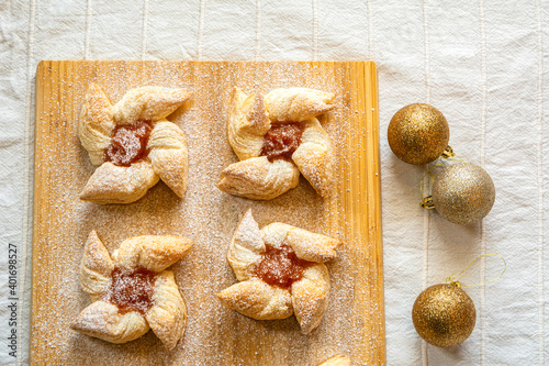 Joulutorttu, traditional finnish christmas pastry with marmalade on the wooden board and christmas balls photo