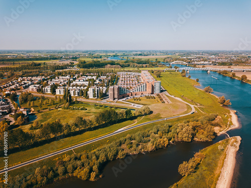 Aerial drone shot of the suburban near the big river in the Netherlands. 