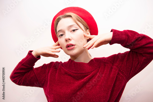 Young beautiful girl in a red beret isolated on a white background