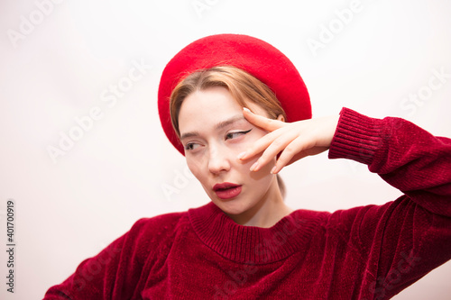 Young beautiful girl in a red beret isolated on a white background