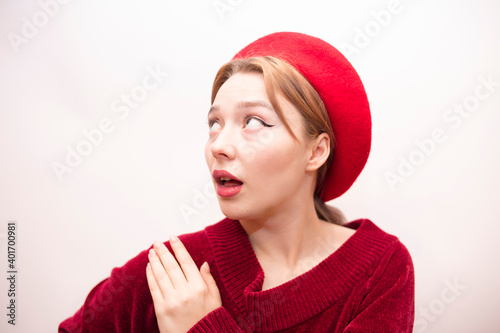Young beautiful girl in a red beret isolated on a white background