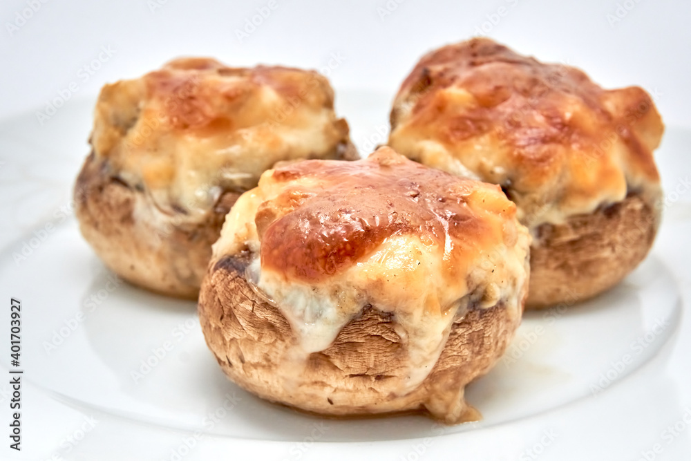 Champignons stuffed with cheese, chicken baked in the oven.