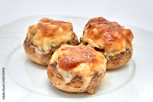 Champignons stuffed with cheese, chicken baked in the oven.
