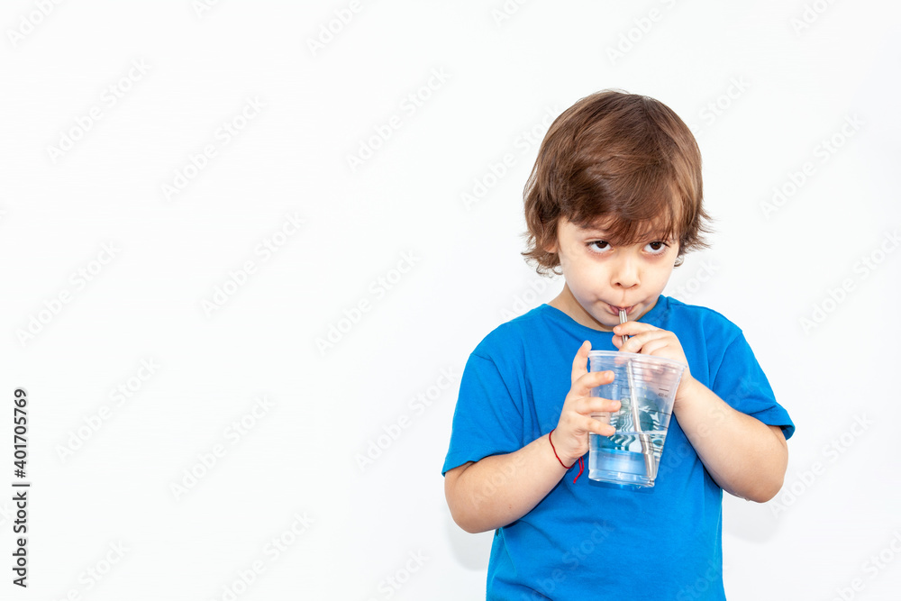 portrait of a boy with a glass of water on a light background portrait of a boy with a glass of water on a light background