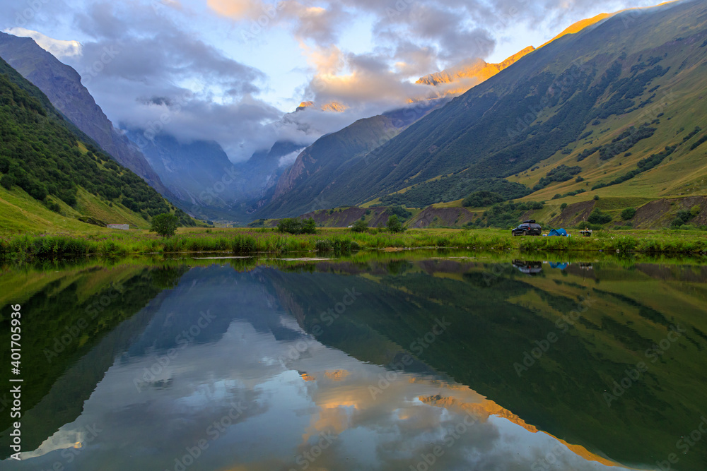 Beautiful mountain landscape with lake at dawn in the valley.