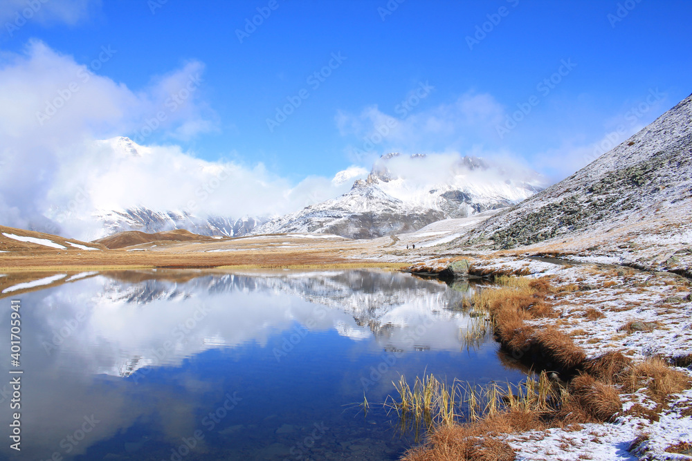 Amazing reflections in lake Plan du Lac Bellecombe looking towards La Grande Casse in the French alps
