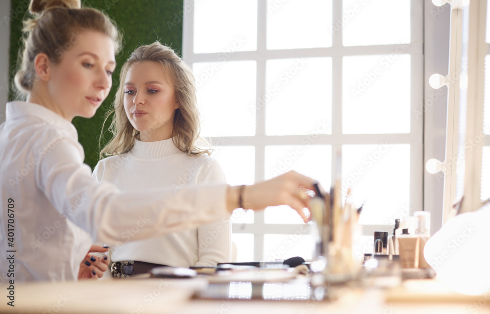 Make-up artist doing make up for young beautiful bride applying wedding make-up Make-up artist doing make up for young beautiful bride applying wedding make-up