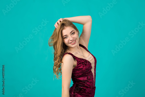 Sexy snow maiden costume on blue background in studio, caucasian lady in dress posing at camera.