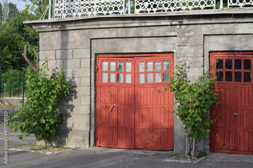 facade of the old stable with red gates