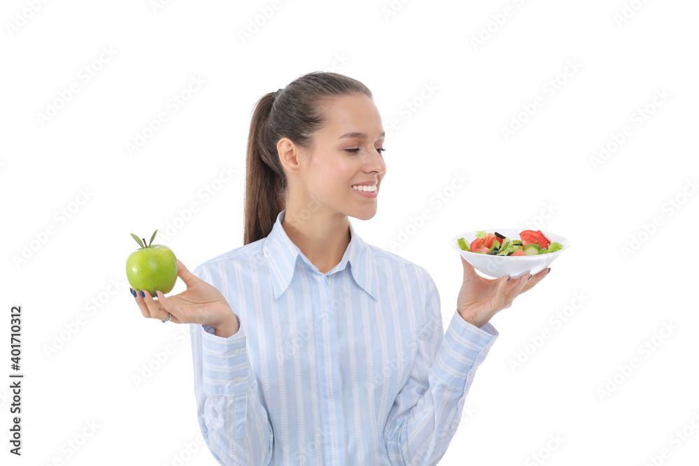 Portrait of a beautiful woman doctor holding a plate with fresh vegetables and green apple. Woman doctor Portrait of a beautiful woman doctor holding a plate with fresh vegetables and green apple. Woman doctor