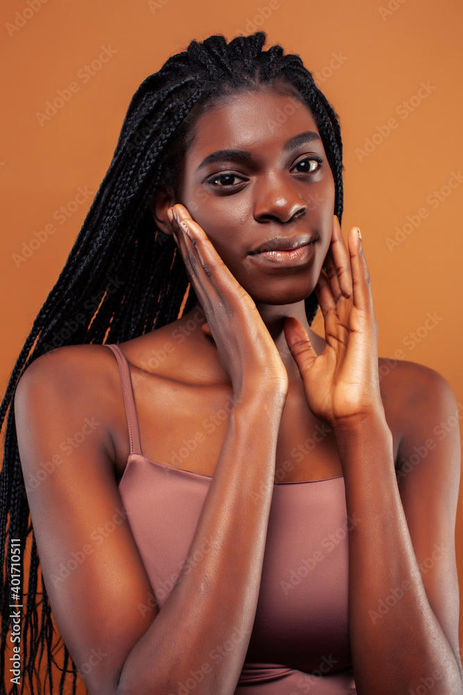 pretty young african american woman posing cheerful gesturing on brown background, lifestyle people concept pretty young african american woman posing cheerful gesturing on brown background, lifestyle people concept