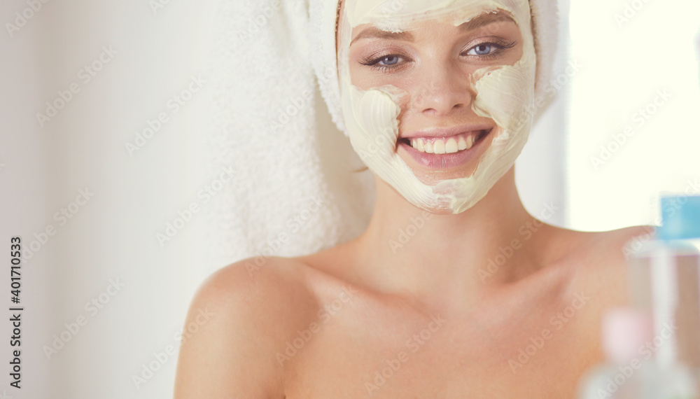 A picture of a young woman applying face powder in the bathroom