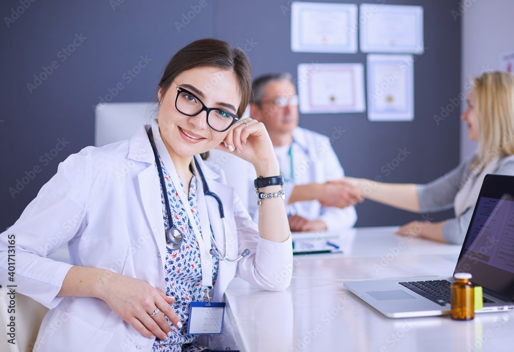 Doctor and patient discussing something while sitting at the table . Medicine and health care concept