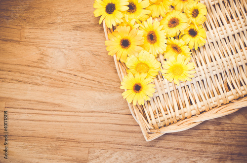 A top view of yellow gerbera flowers on a wooden background - still life photography photo