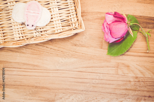 A top view of a beautiful rose on a wooden background - still life photo