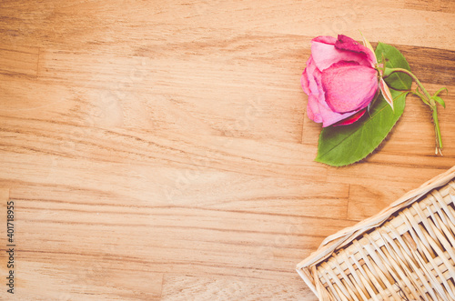 A top view of a beautiful rose on a wooden background - still life photo