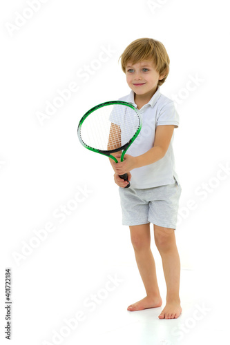 Cute little boy playing tennis.