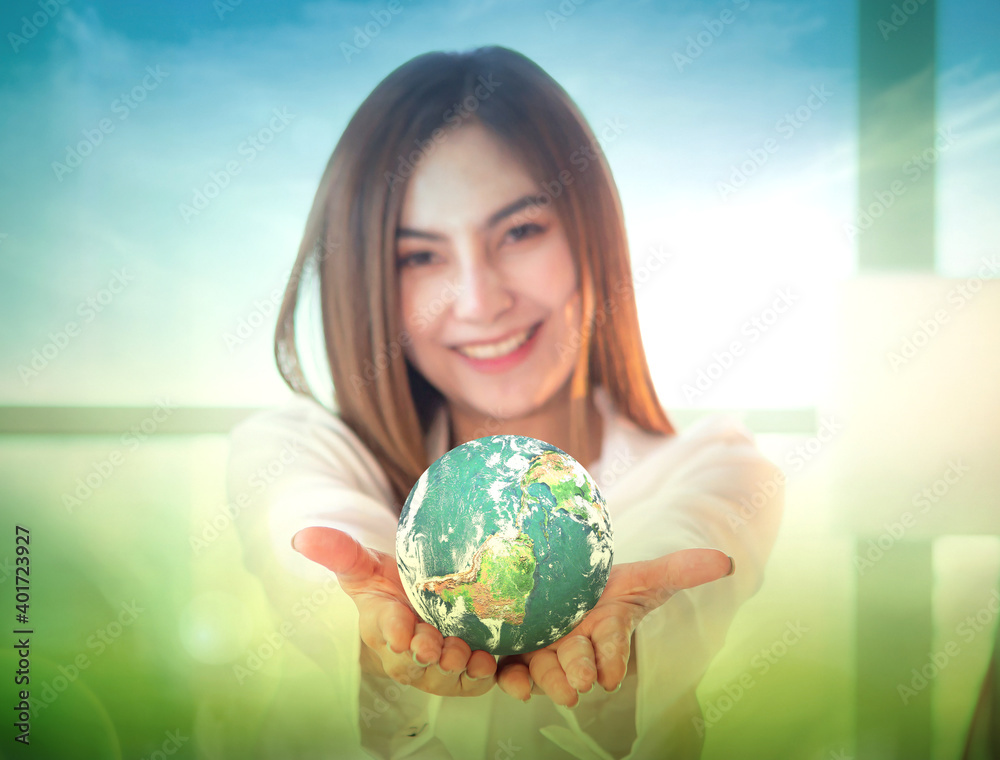World environment day concept: Selective focus green earth, Asian woman giving world. Elements of this image furnished by NASA World environment day concept: Selective focus green earth, Asian woman giving world. Elements of this image furnished by NASA