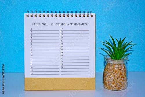 April 2021 Doctor Appointment calendar with blue background and potted plant