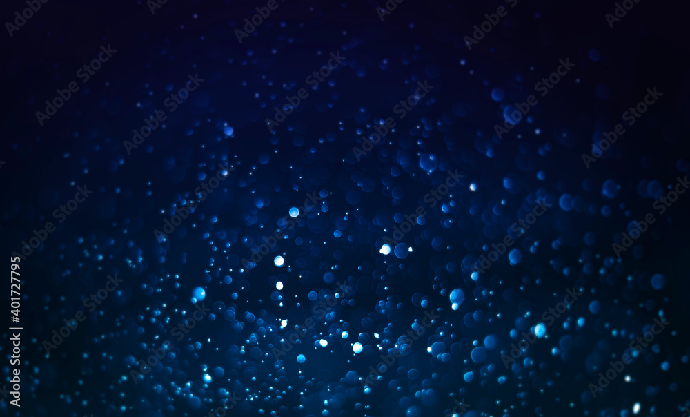Abstract blue dust dark background. Bokeh blur, defocused on black background.