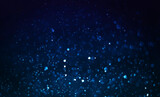 Abstract blue dust dark background. Bokeh blur, defocused on black background.