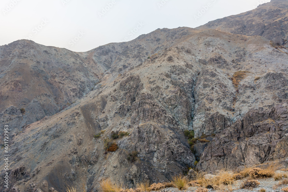 Canyon with rocks and dead grass in autumn in the Tochal mountain, Tehran, Iran. Tochal is a popular recreational region for Tehran's residents Canyon with rocks and dead grass in autumn in the Tochal mountain, Tehran, Iran. Tochal is a popular recreational region for Tehran's residents