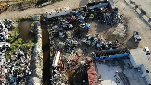 Wallpaper Mural Aerial top view of damage old cars being recycle for steel. Old damage wreck cars piled up on a junk yard. Crane picking up junk yard cars to pile them for recycling.  Torontodigital.ca