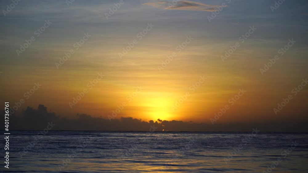 Beautiful sunrise over the Indian Ocean on the island of Zanzibar, Tanzania, east Africa. Travel and nature concept. Sun, blue sky and sea water Beautiful sunrise over the Indian Ocean on the island of Zanzibar, Tanzania, east Africa. Travel and nature concept. Sun, blue sky and sea water