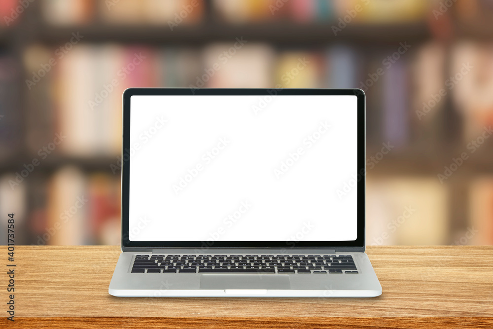 Laptop and blank white screen on wooden table top with bookshelf in library room in background. Laptop and blank white screen on wooden table top with bookshelf in library room in background.