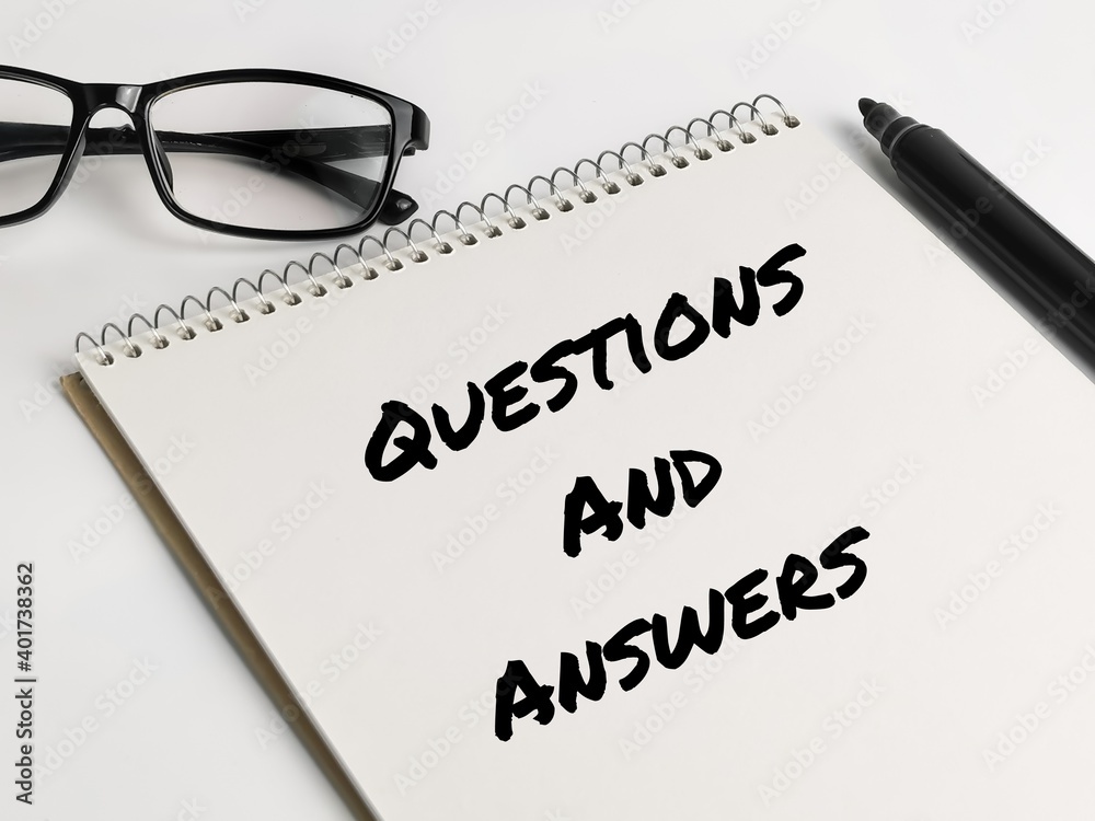 Text QUESTIONS AND ANSWERS on notebook with marker pen and eye glasses.Business concept. Text QUESTIONS AND ANSWERS on notebook with marker pen and eye glasses.Business concept.