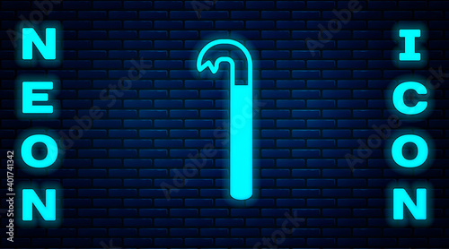 Glowing neon Crowbar icon isolated on brick wall background. Vector Illustration.