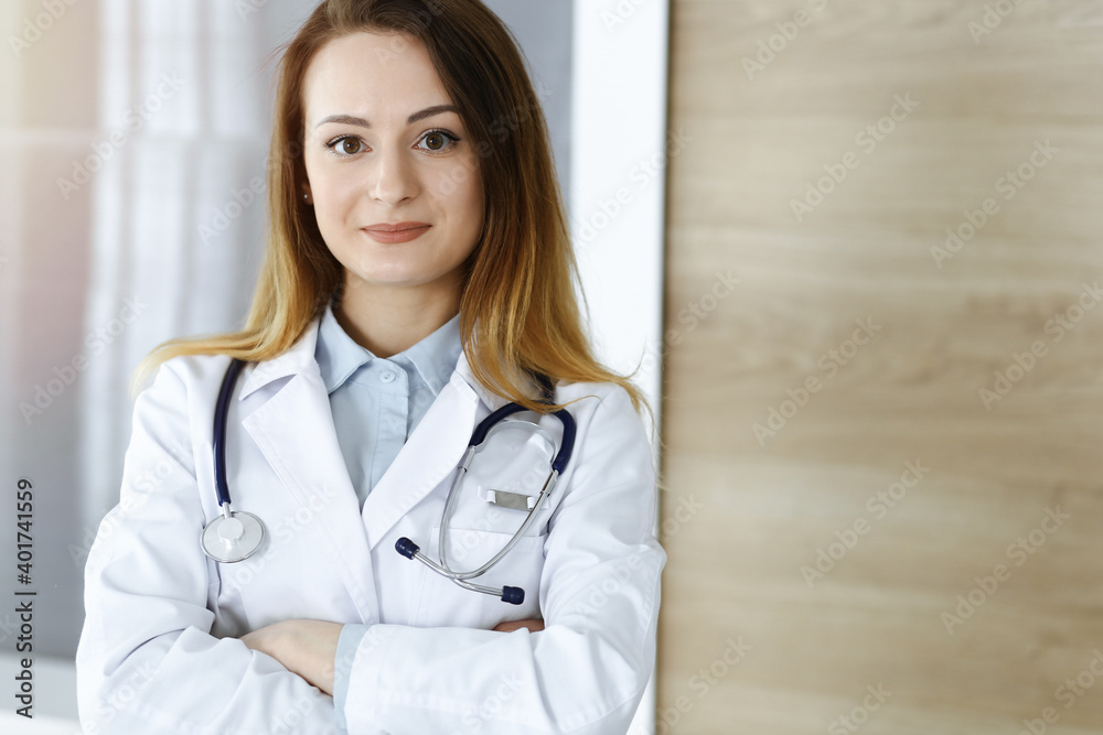 Doctor woman headshot while standing in hospital office. Physician at workplace, portrait photo. Medicine and health care concept Doctor woman headshot while standing in hospital office. Physician at workplace, portrait photo. Medicine and health care concept