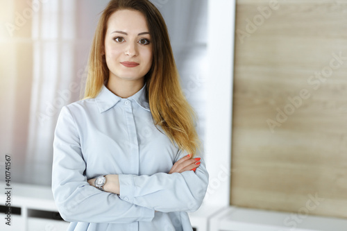 Business woman headshot in sunny office. Unknown businesswoman standing straight with tablet computer. Young accountant or secretary looks good Free Download Business woman headshot in sunny office. Unknown businesswoman standing straight with tablet computer. Young accountant or secretary looks good - GFXLoad