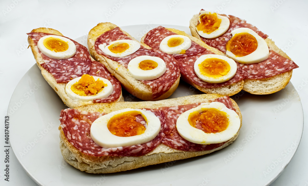 Appetizer with bread, salami and hard-boiled eggs, isolated on white background Appetizer with bread, salami and hard-boiled eggs, isolated on white background